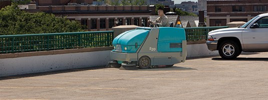 S20 Ride-On Sweeper cleaning a parking ramp