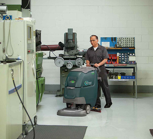 Tennant machine cleaning a facility